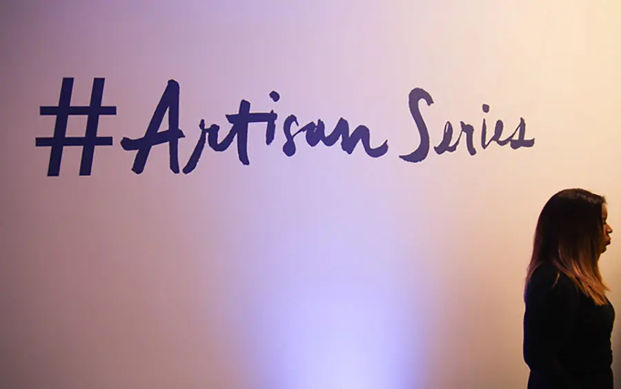 Artisan Series lettering projected across a gallery wall