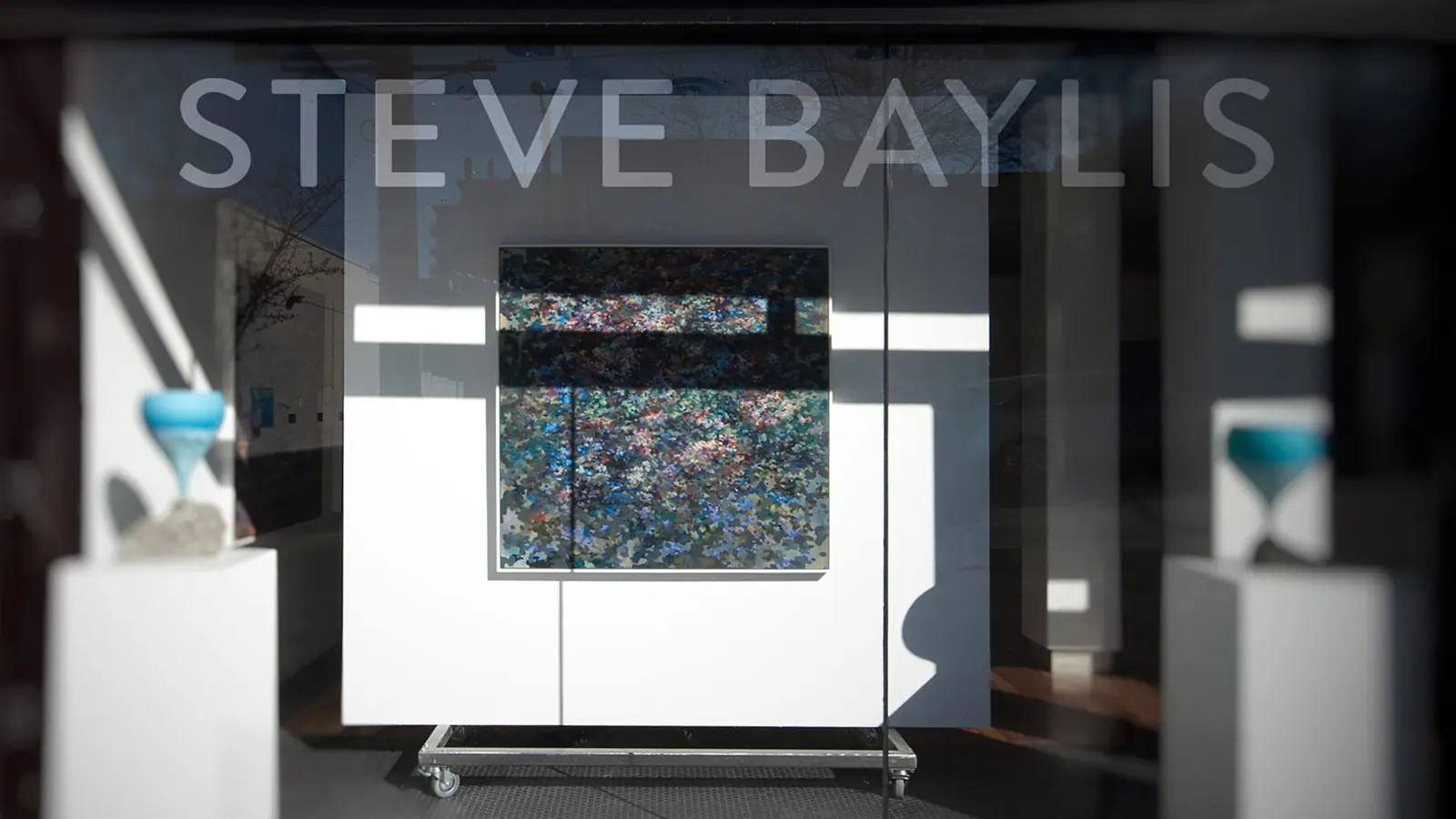 Steve Baylis name displayed across the gallery window above a painting