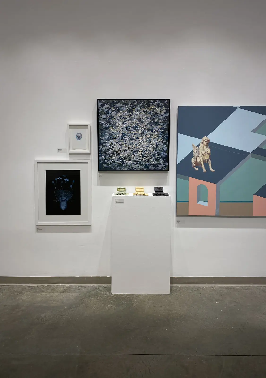 Abstract painting displayed with other works on a gallery wall